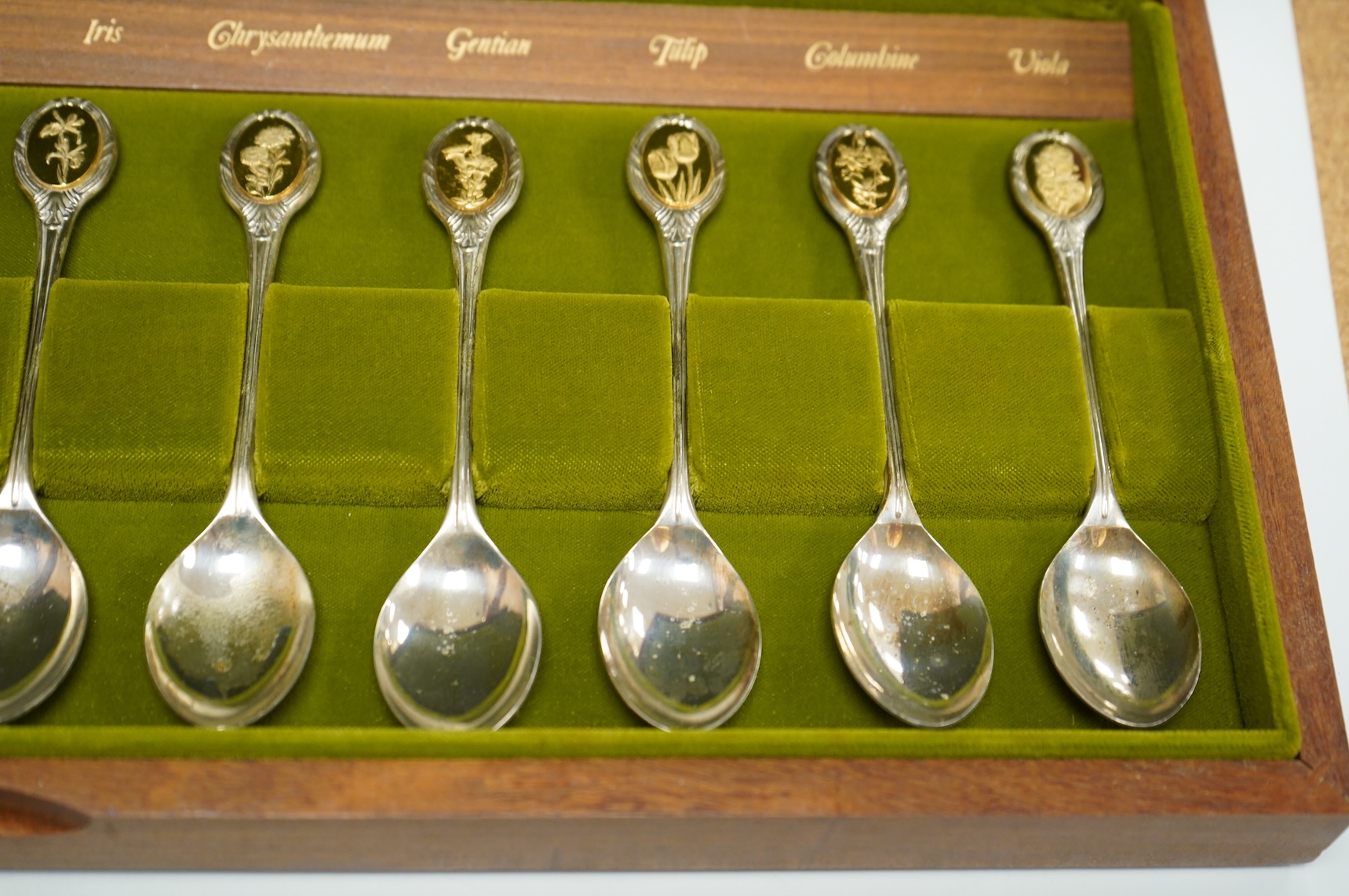 A cased set of twelve Elizabeth II parcel gilt silver Royal Horticultural Society spoons, by John Pinches, Sheffield, 1974.